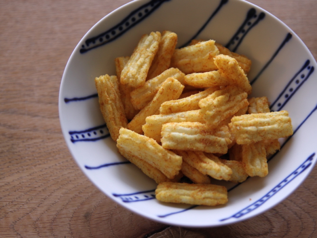 MUJI's deep-fried rice crackers with tomato curry flavor served on a plate