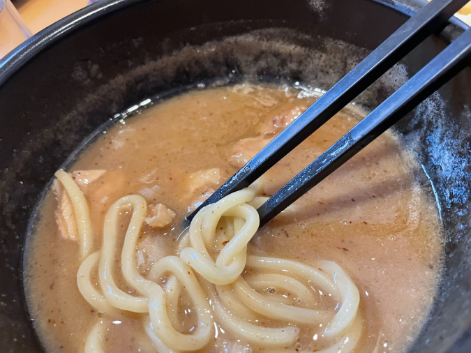 博多くまちゃんらぁめん 春日店　濃厚つけ麺を食べているシーン