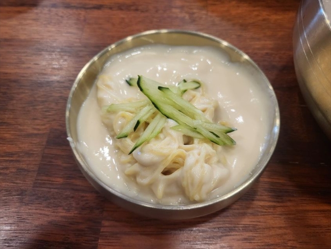 オコンのコングクスの上に細切りきゅうりをのせる